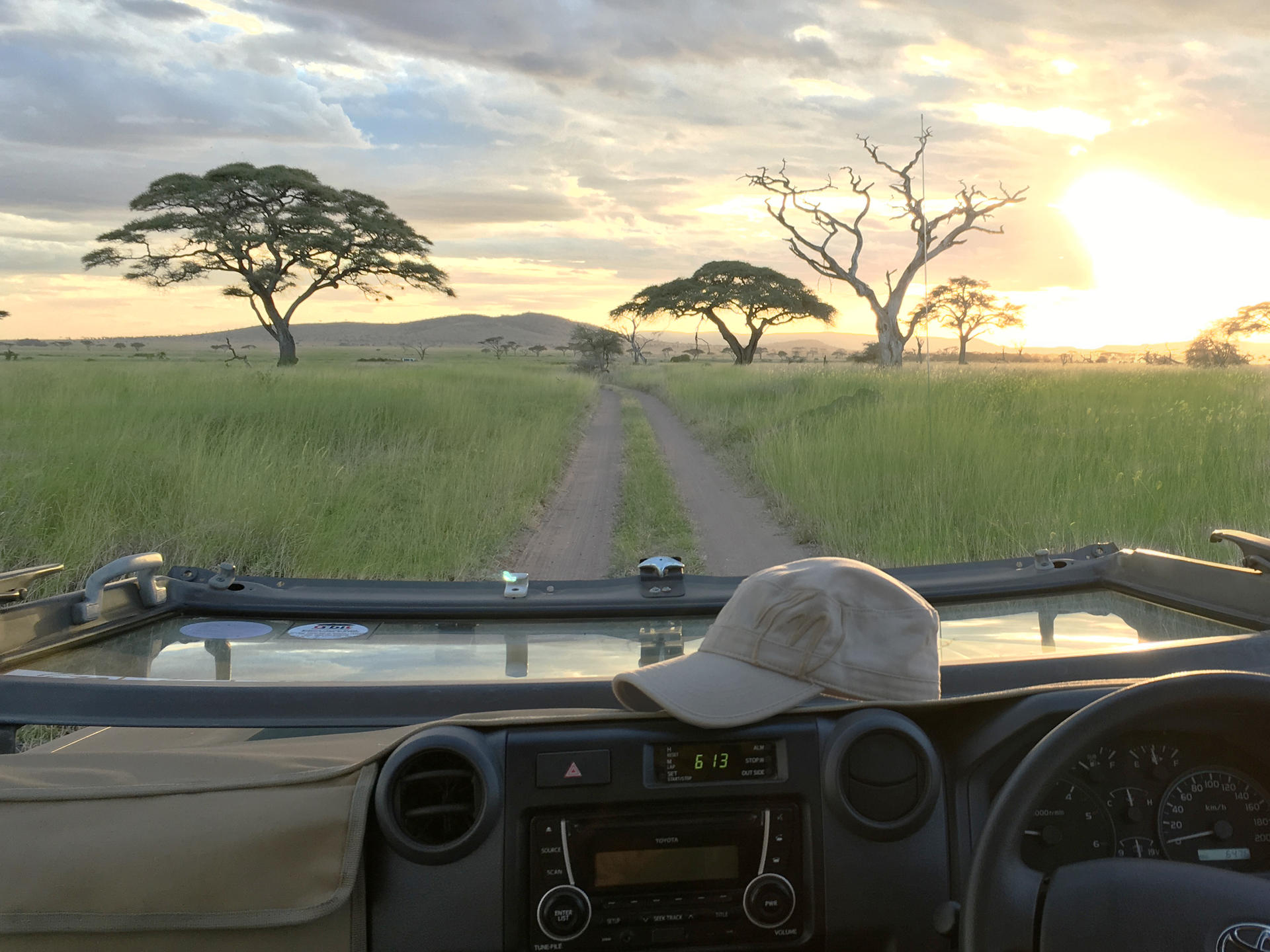Safari vehicle in open East African landscape